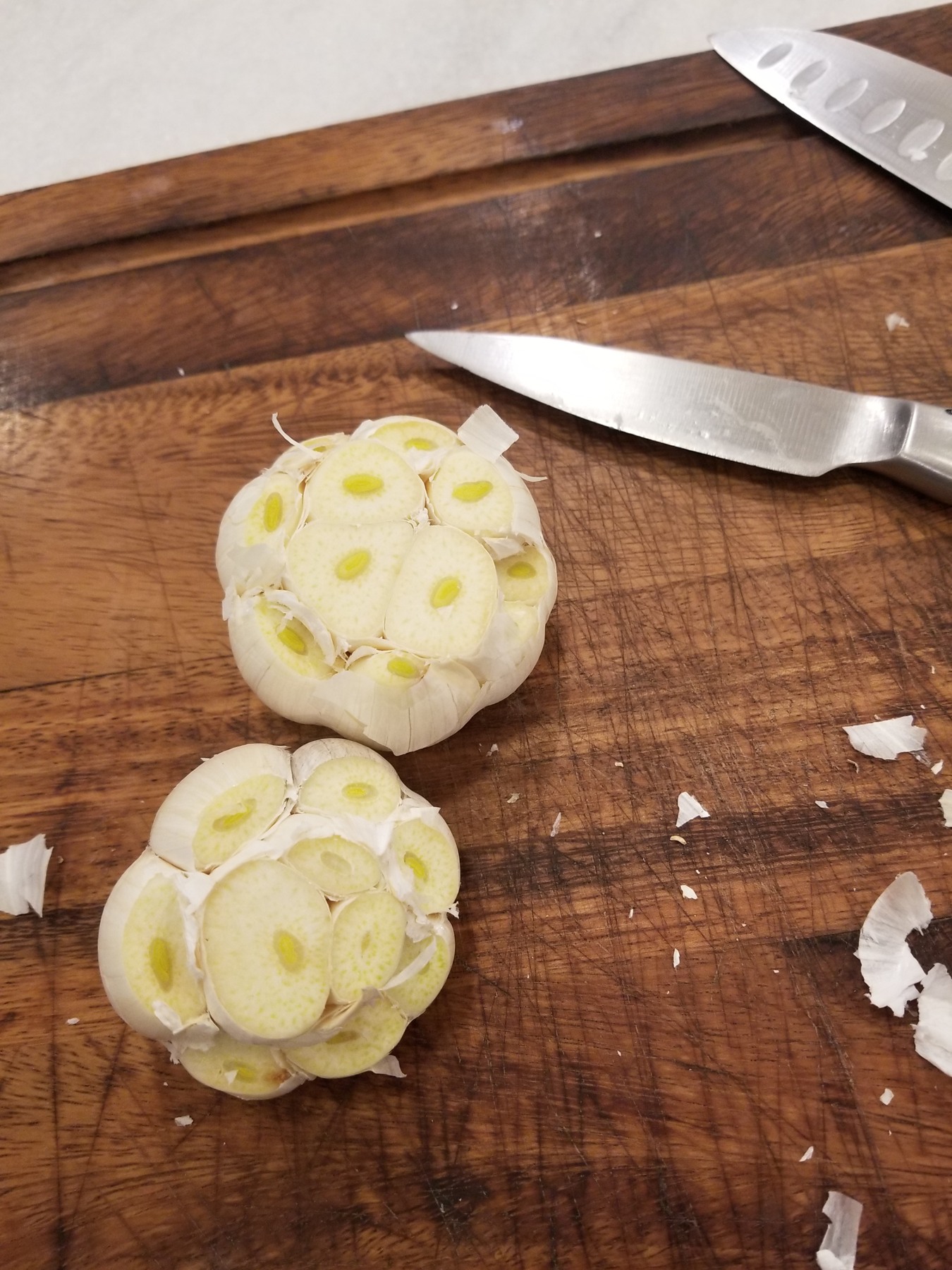Garlic bulbs with their tops cut off to expose the cloves.